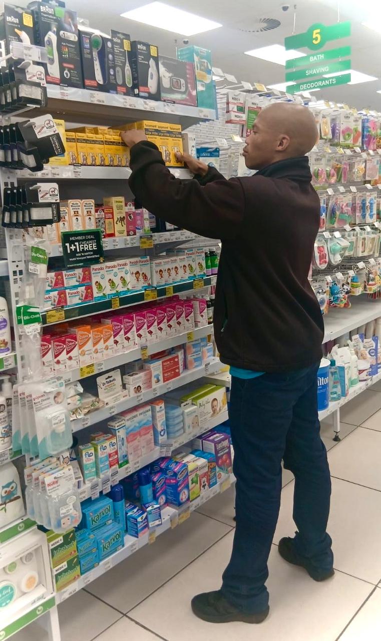 SEAL merchandiser working stock on a pharmacy shelf